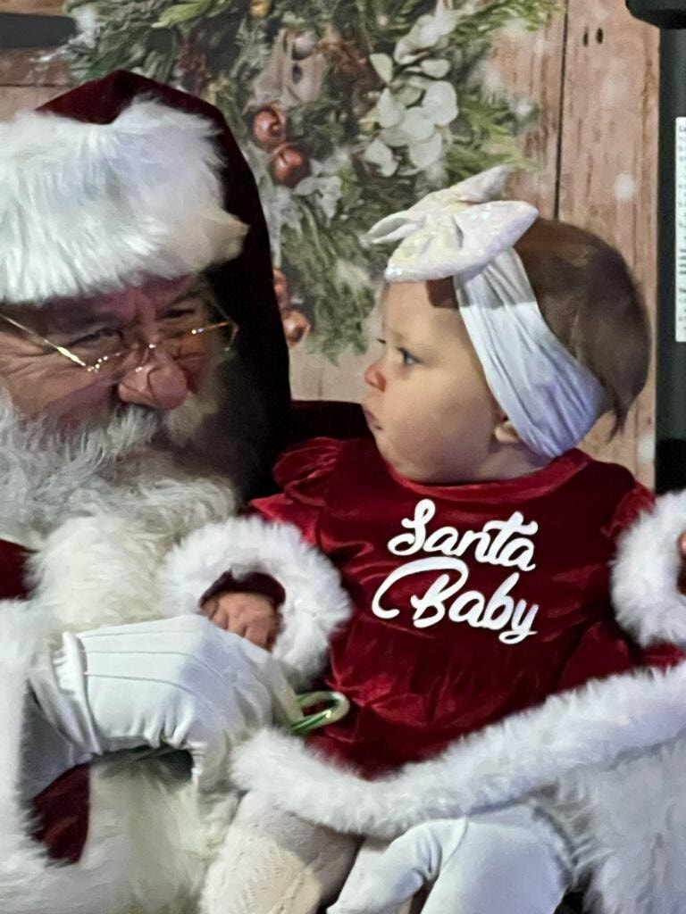 Santa Claus with a family during the Morton Family Lights event